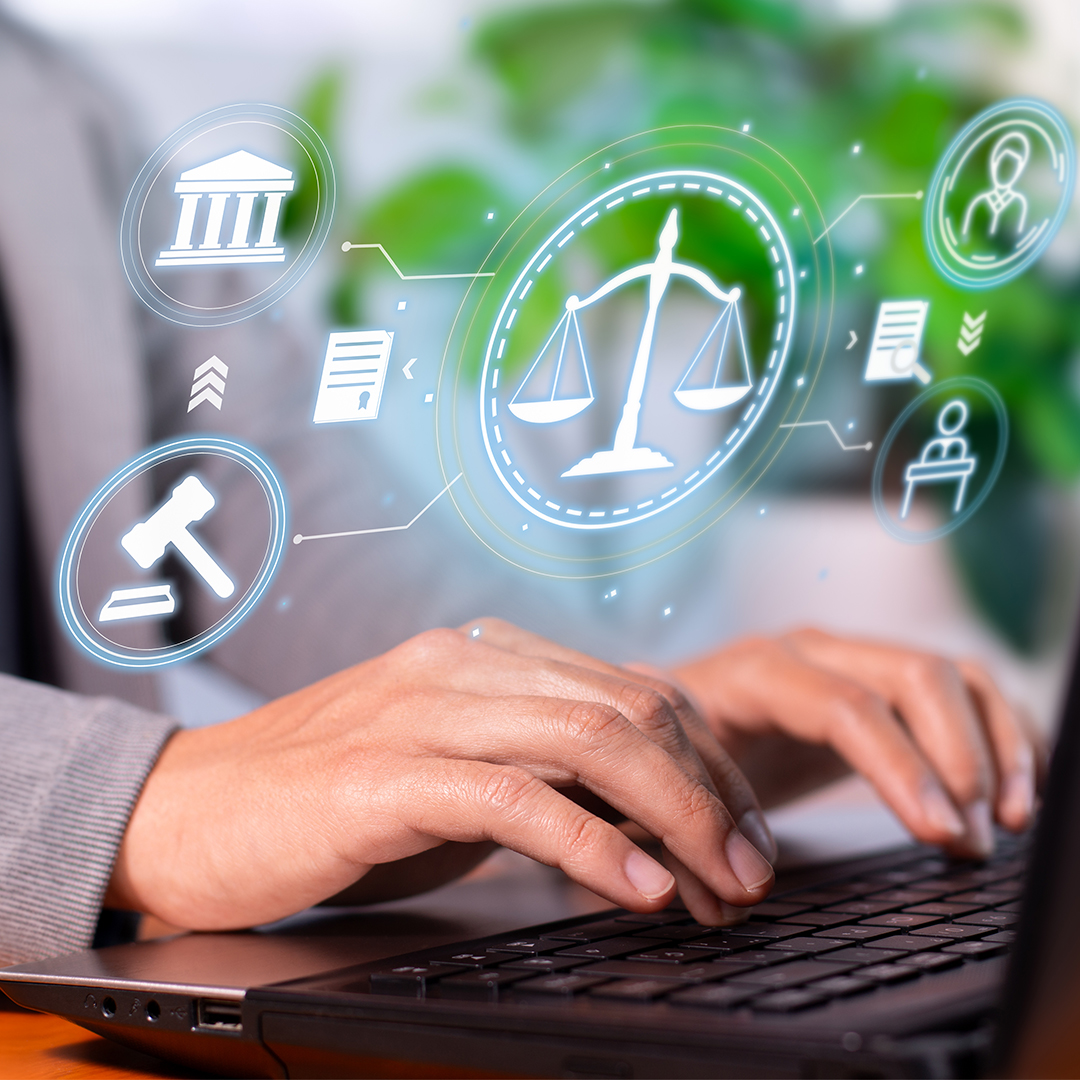 Person typing on a laptop keyboard with floating digital icons depicting legal concepts such as scales of justice, courthouse, gavel, documents, and business figures.