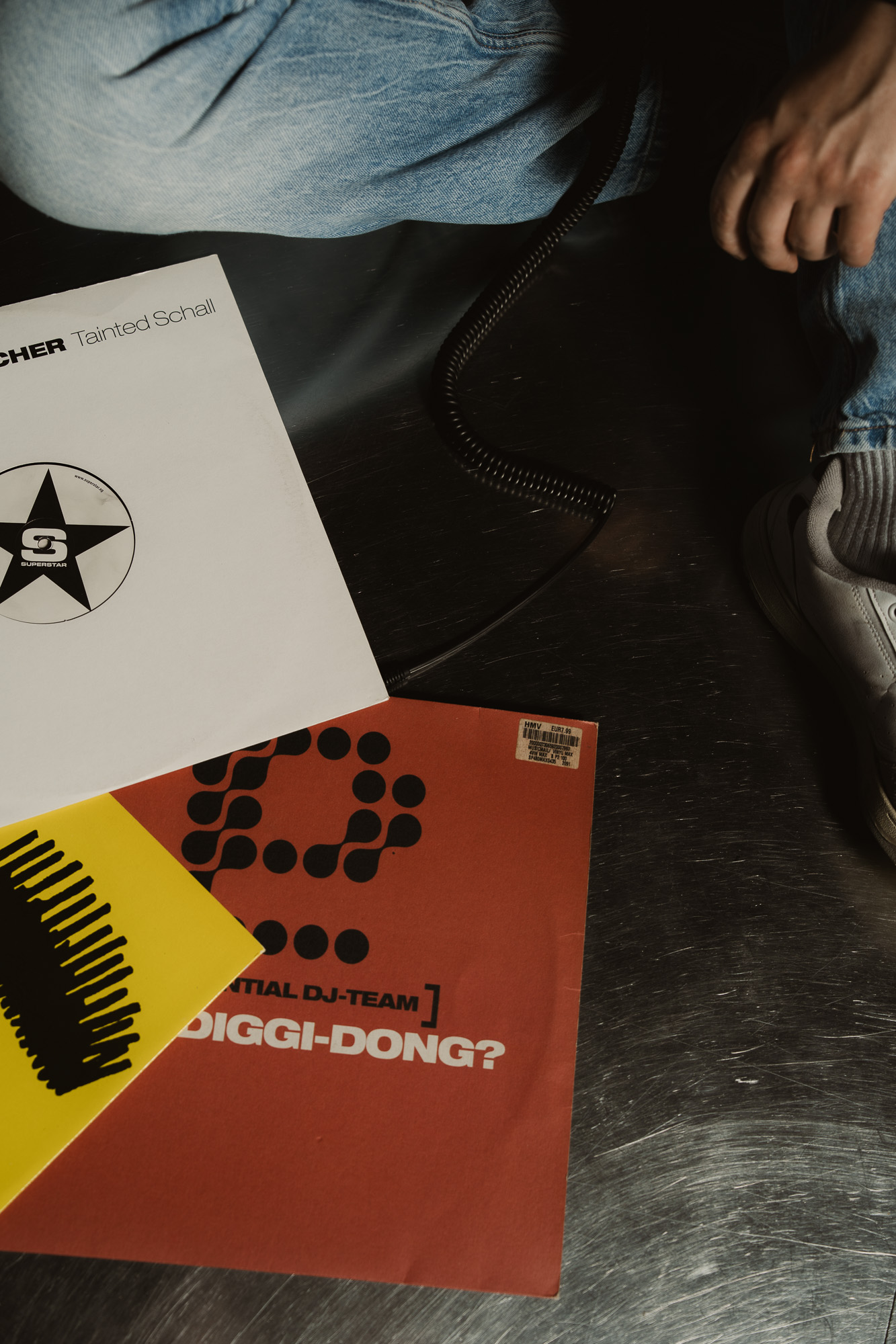 Vinyl records and colourful album artwork arranged on a dark surface.