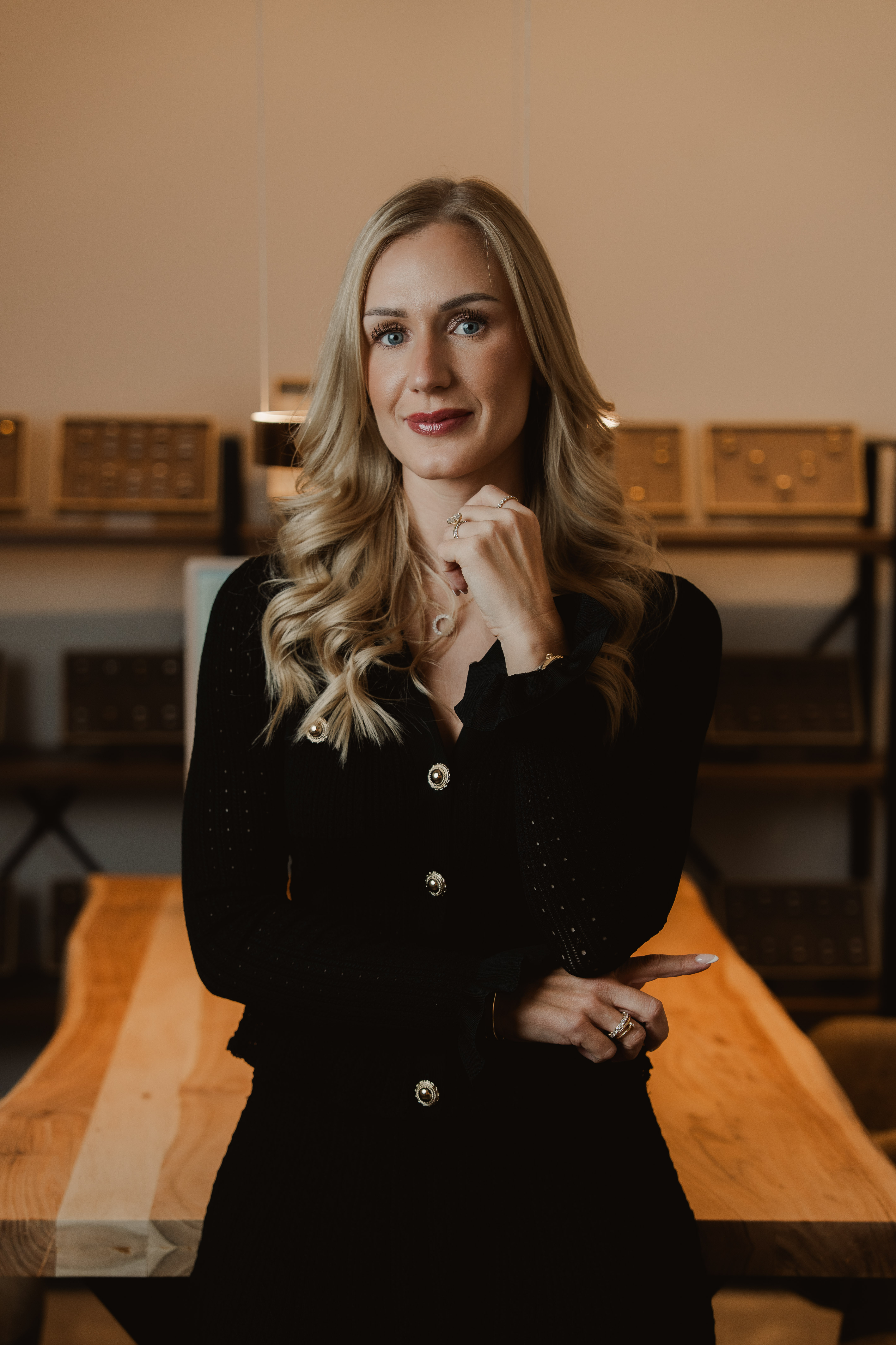 Portrait of a blonde woman seated inside the Traumringe jewellery store.