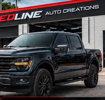 Leveled truck in front of Redline Auto Creations