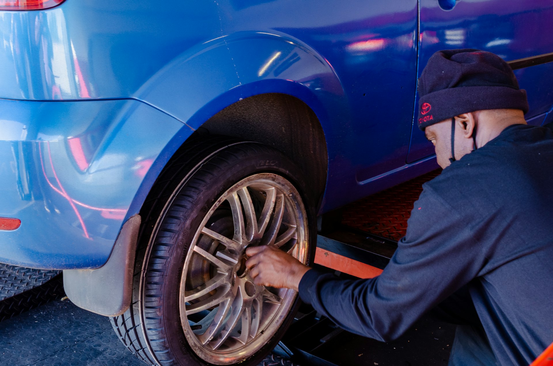 Mechanic inspecting vehicle alignment