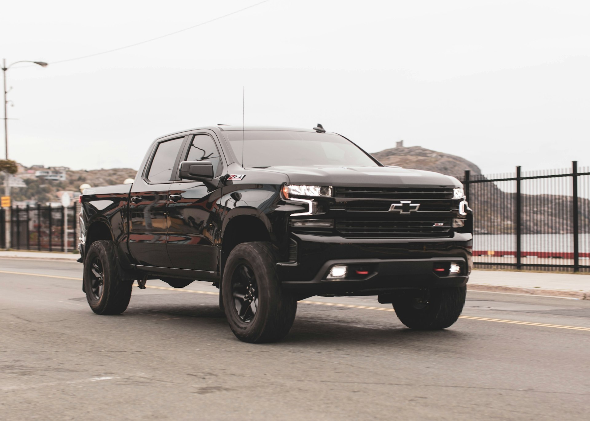 Black lifted Chevy truck with custom wheels and accessories