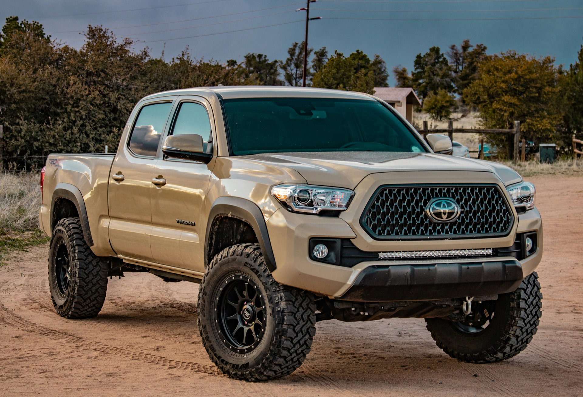 White Toyota truck with lift kit and accessories