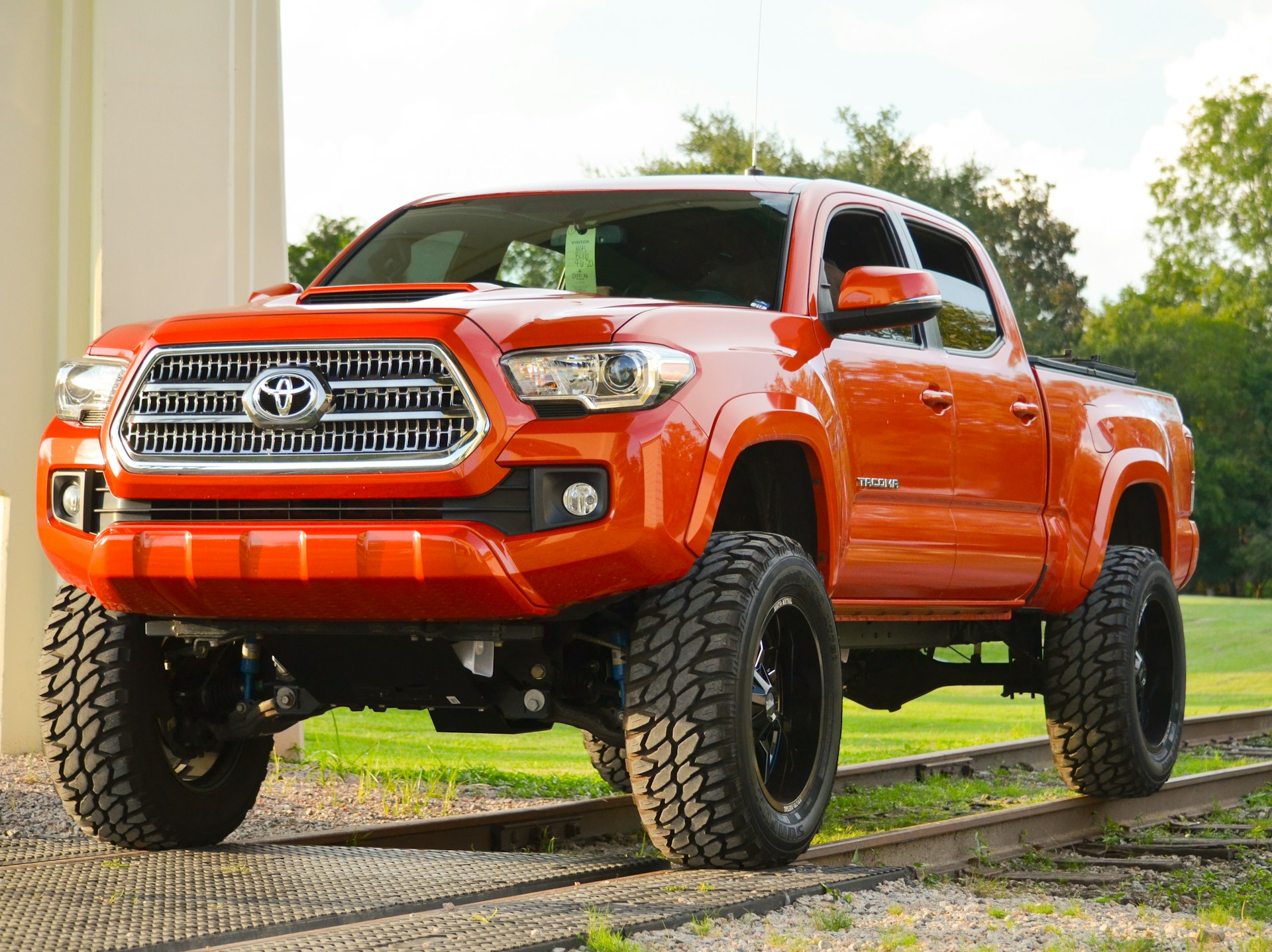 Red crew cab truck with aftermarket accessories