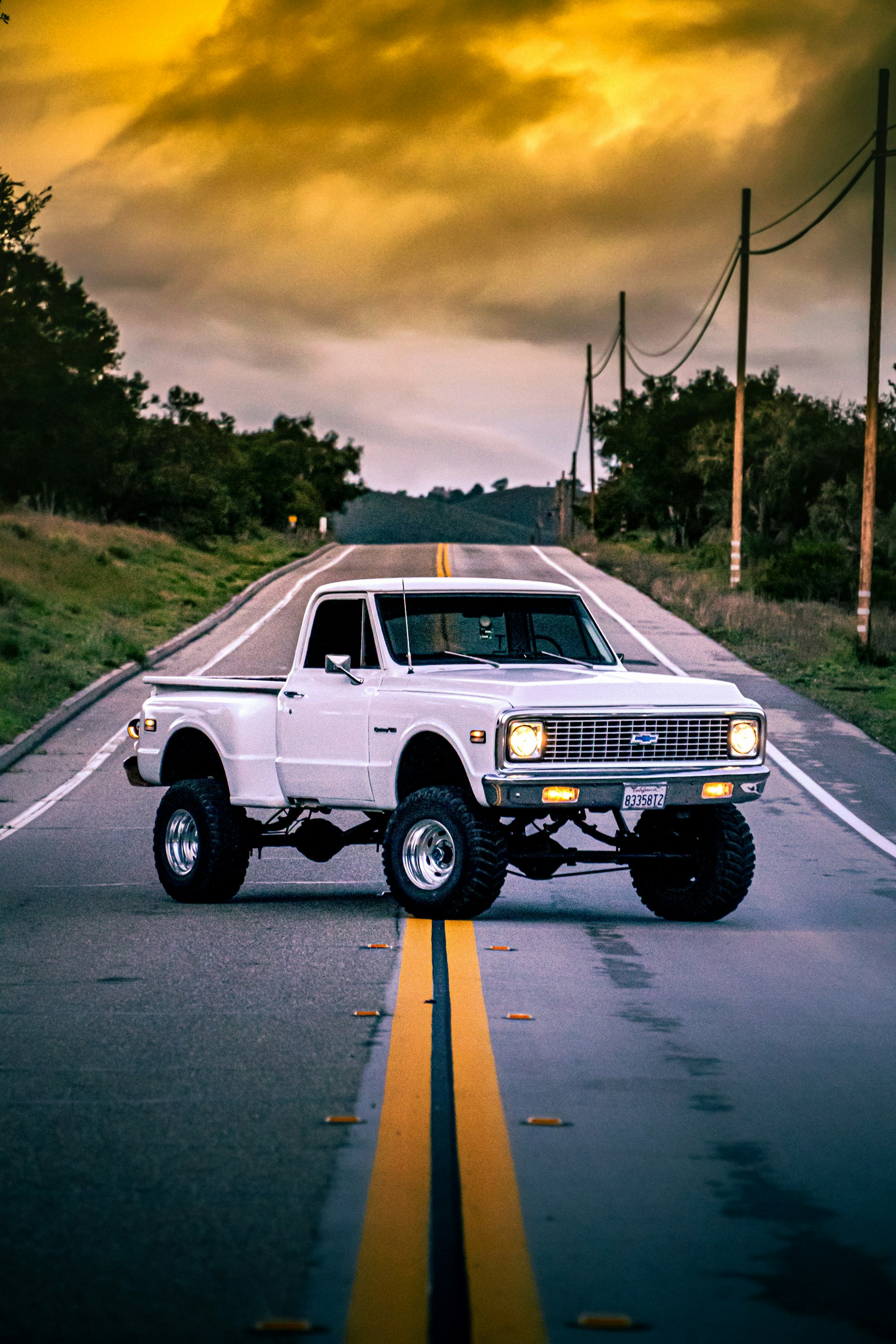 White truck on road with custom accessories