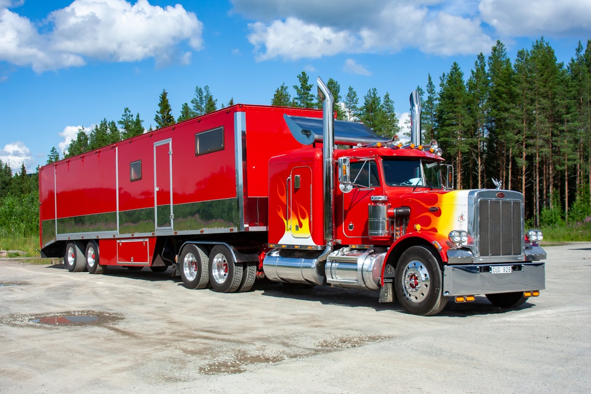 Red truck towing on the road