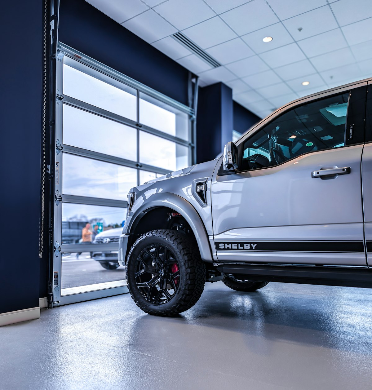 Silver Shelby truck in showroom with custom setup