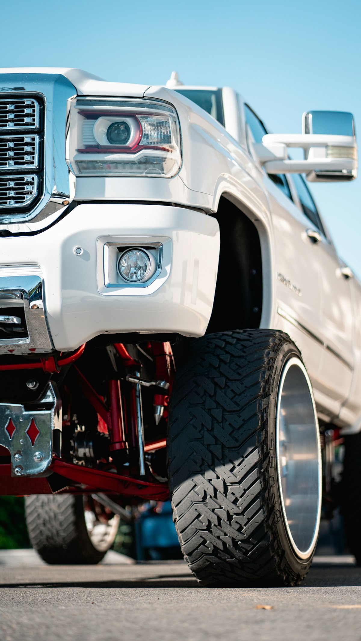 Large white lifted truck in parking lot