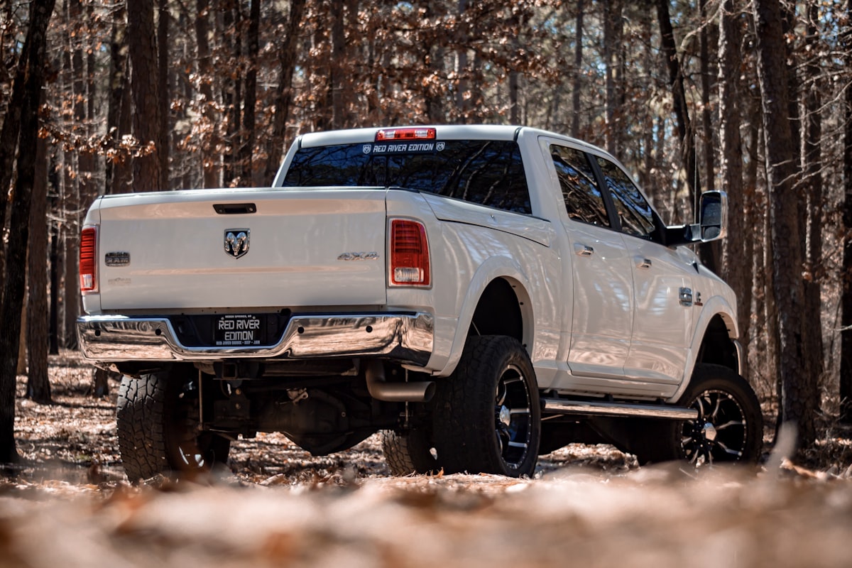 White Dodge crew cab pickup truck with lift