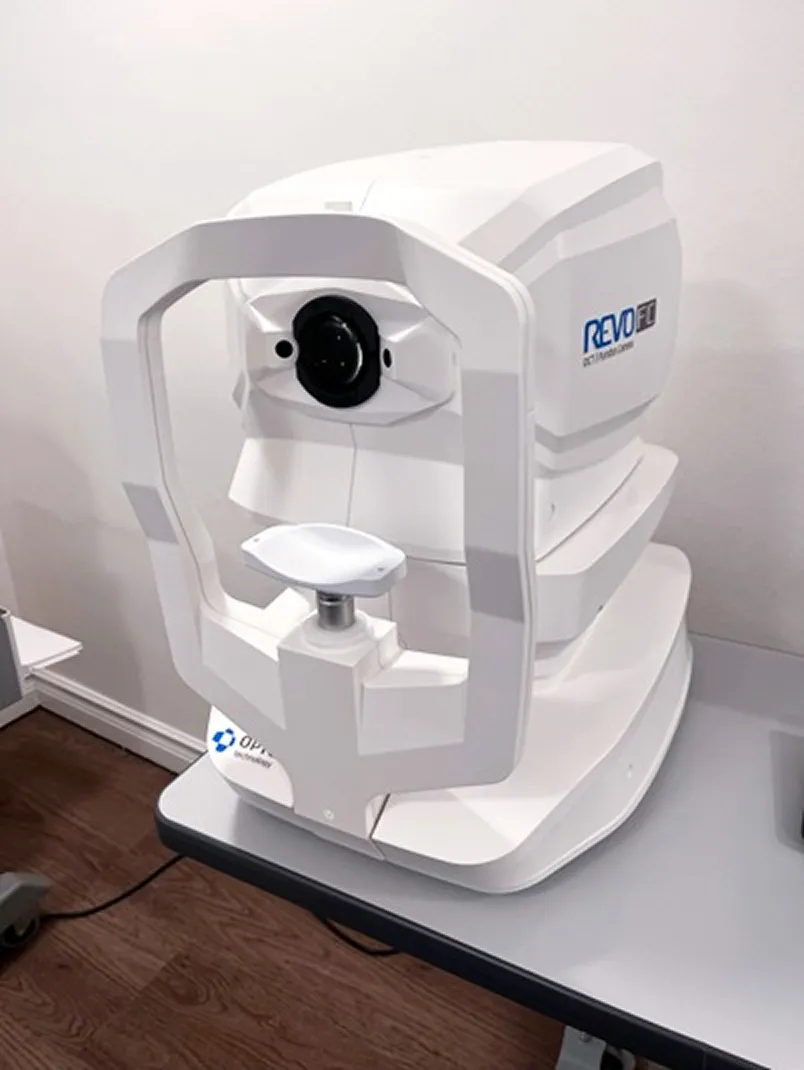 A REVO OCT scanning machine — a modern white optical coherence tomography device used to capture detailed images of the retina