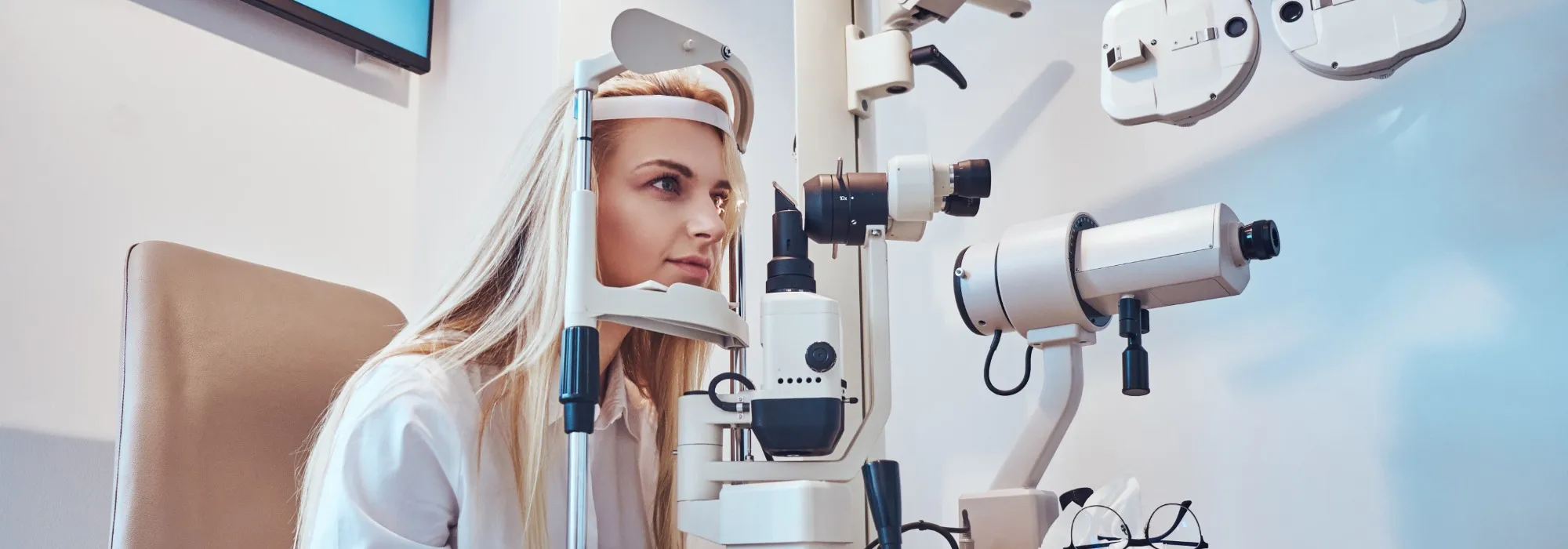 Optician using a slit lamp during an eye examination