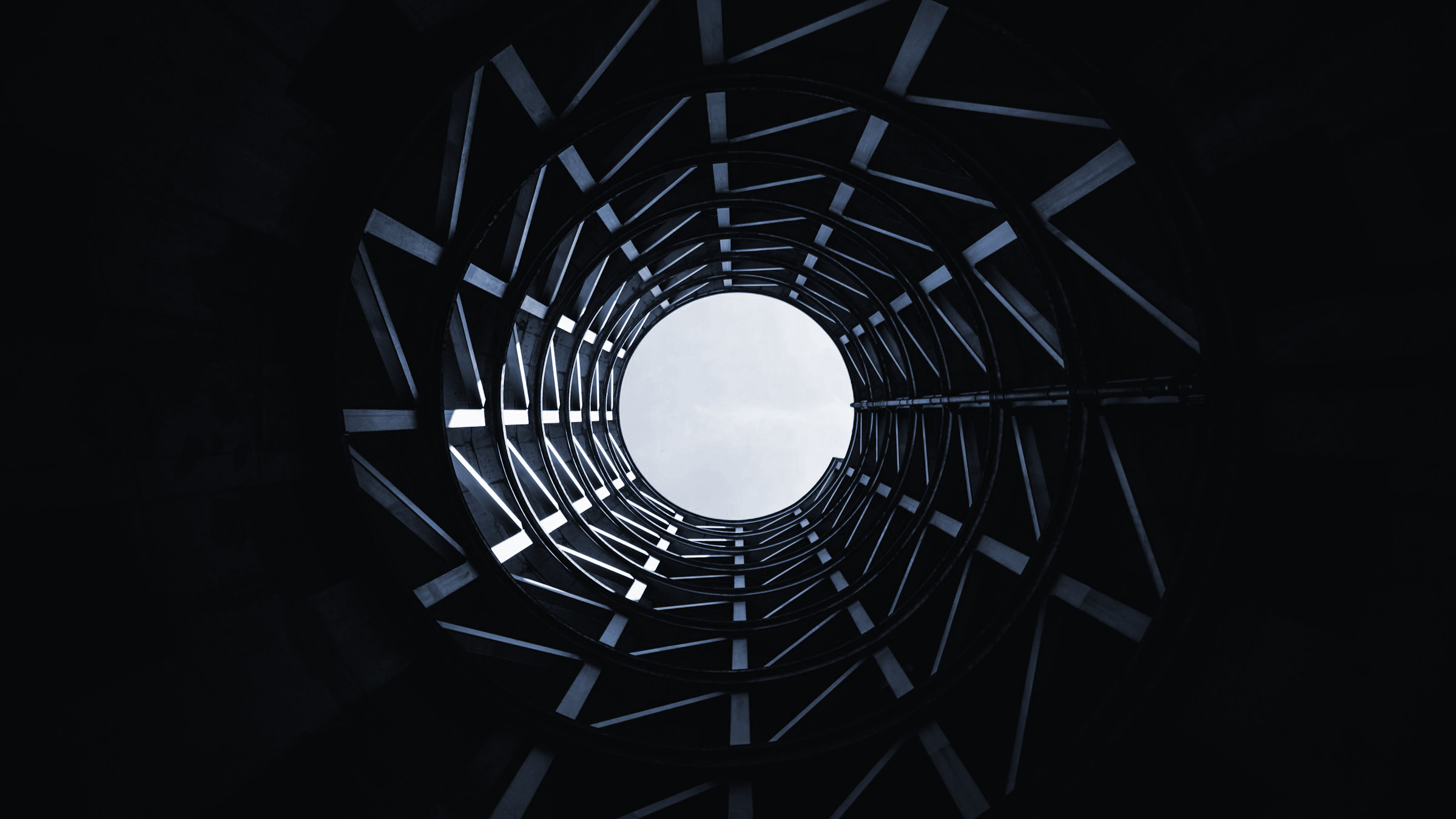 Image of a construction that goes up building an opening in a kind of circle form.