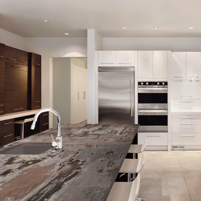 Contemporary kitchen with white and dark wood cabinets, stainless steel appliances and large stone island worktop with sink