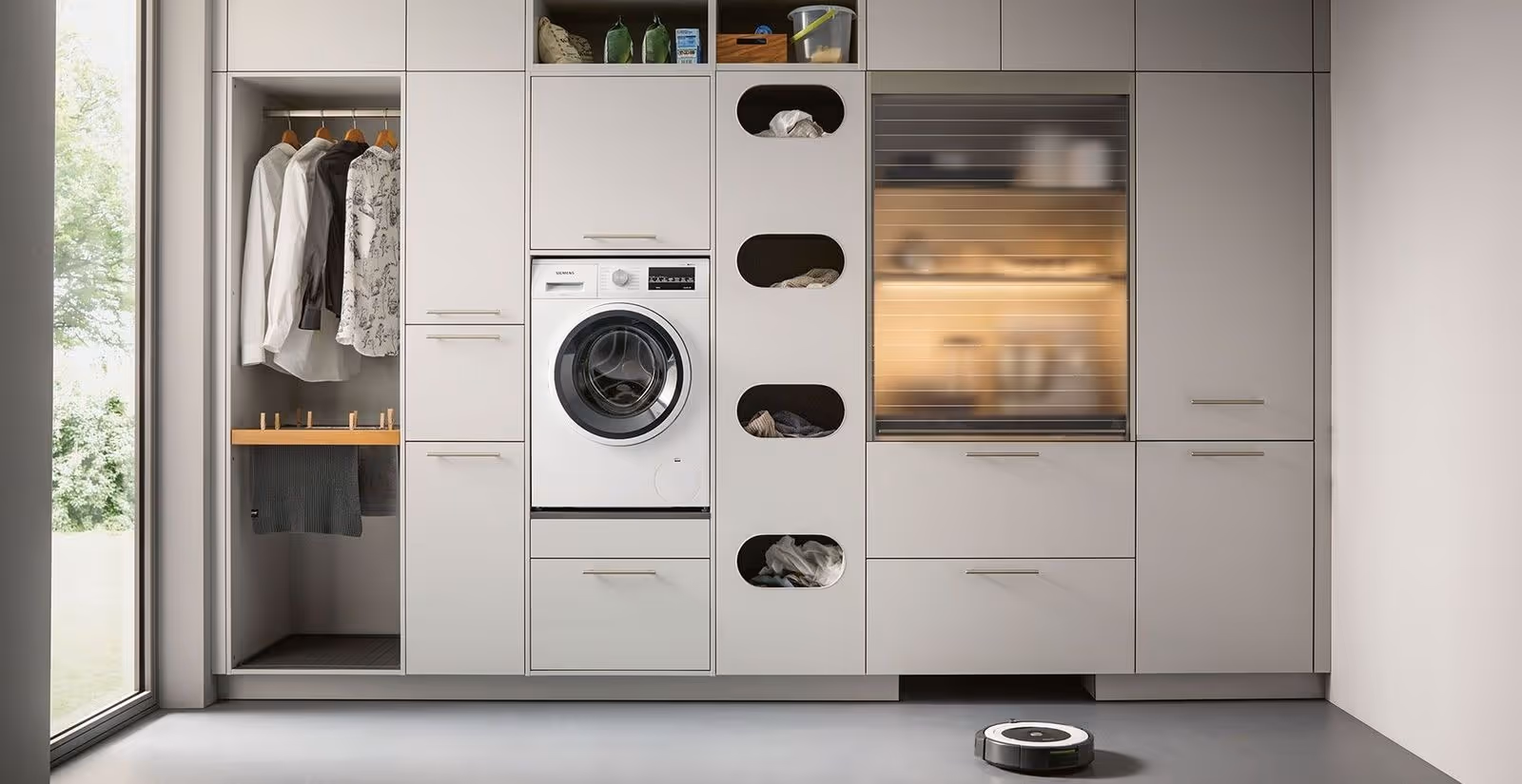 Modern utility room with built-in cabinetry, integrated washing machine, open storage compartments and hanging space for organised laundry solutions