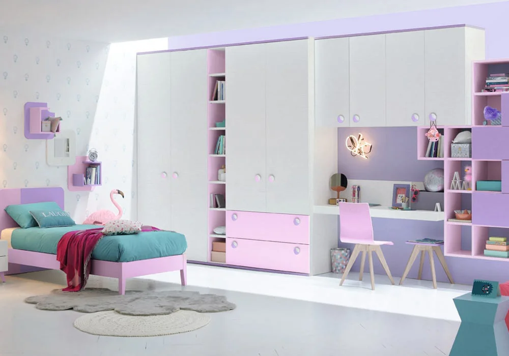 A neat, pastel-themed kids' bedroom with a bed, a large wardrobe, and a study desk.