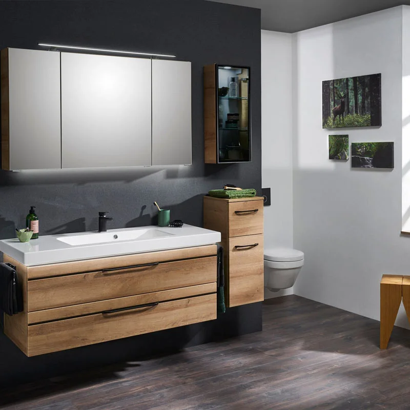Modern bathroom with a wooden vanity, white sink, and wall-mounted mirror cabinet above it.