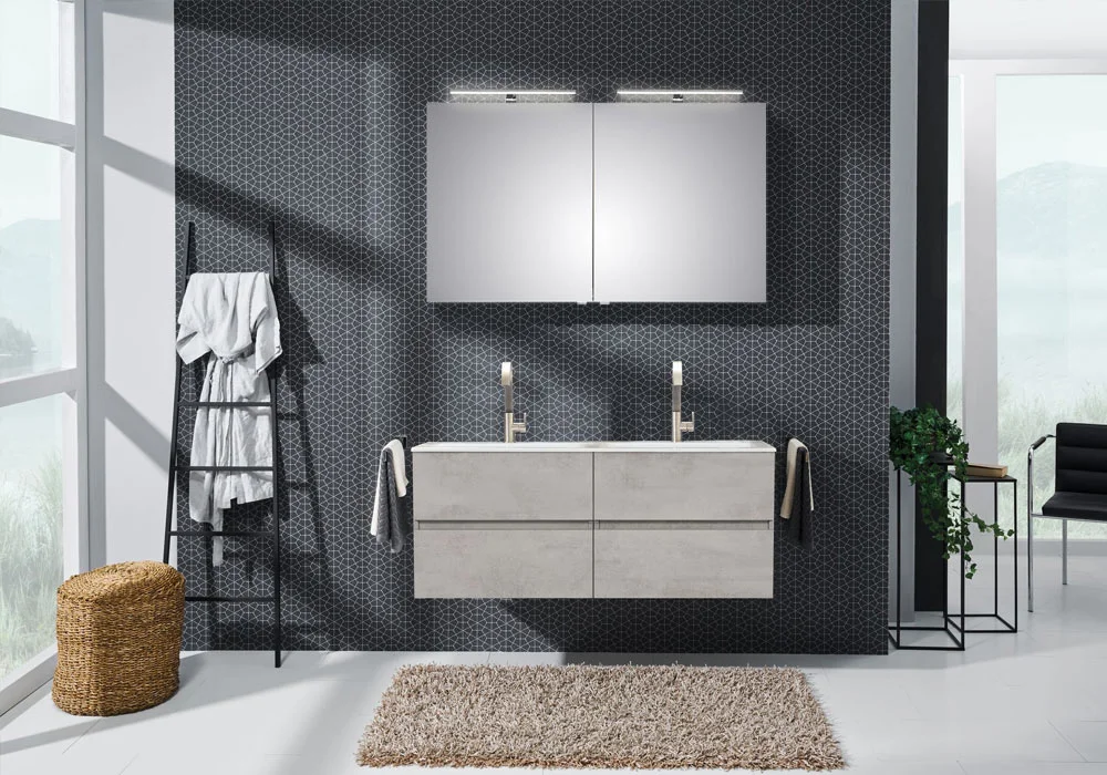 Modern bathroom with double sink, two mirrors, and towel hanging on a black ladder-style rack.