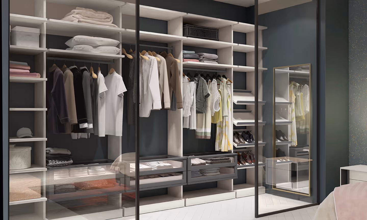A neatly organized walk-in closet with clothes hanging and shoes arranged on shelves.