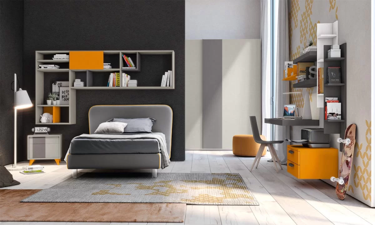 A modern bedroom with a single bed, a shelving unit, a desk, and a skateboard.