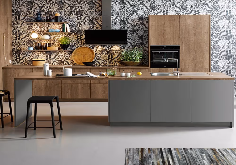 Modern kitchen with wooden cabinets, a large island, bar stools, and patterned tile backsplash.