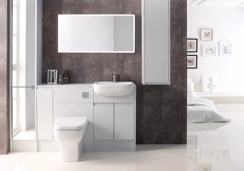 A modern bathroom with a sink, mirror, and toilet against a textured wall.