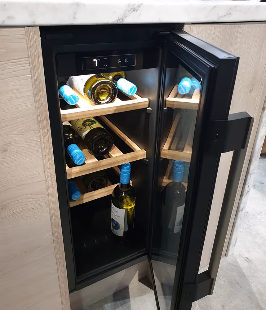 Open refrigerator showing shelves with bottles of wine, some with blue caps.