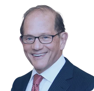 Smiling middle-aged man with glasses wearing a dark suit, white shirt, and red patterned tie.