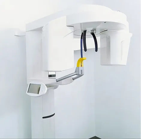 Modern white dental panoramic X-ray machine with digital display screen in a white room.