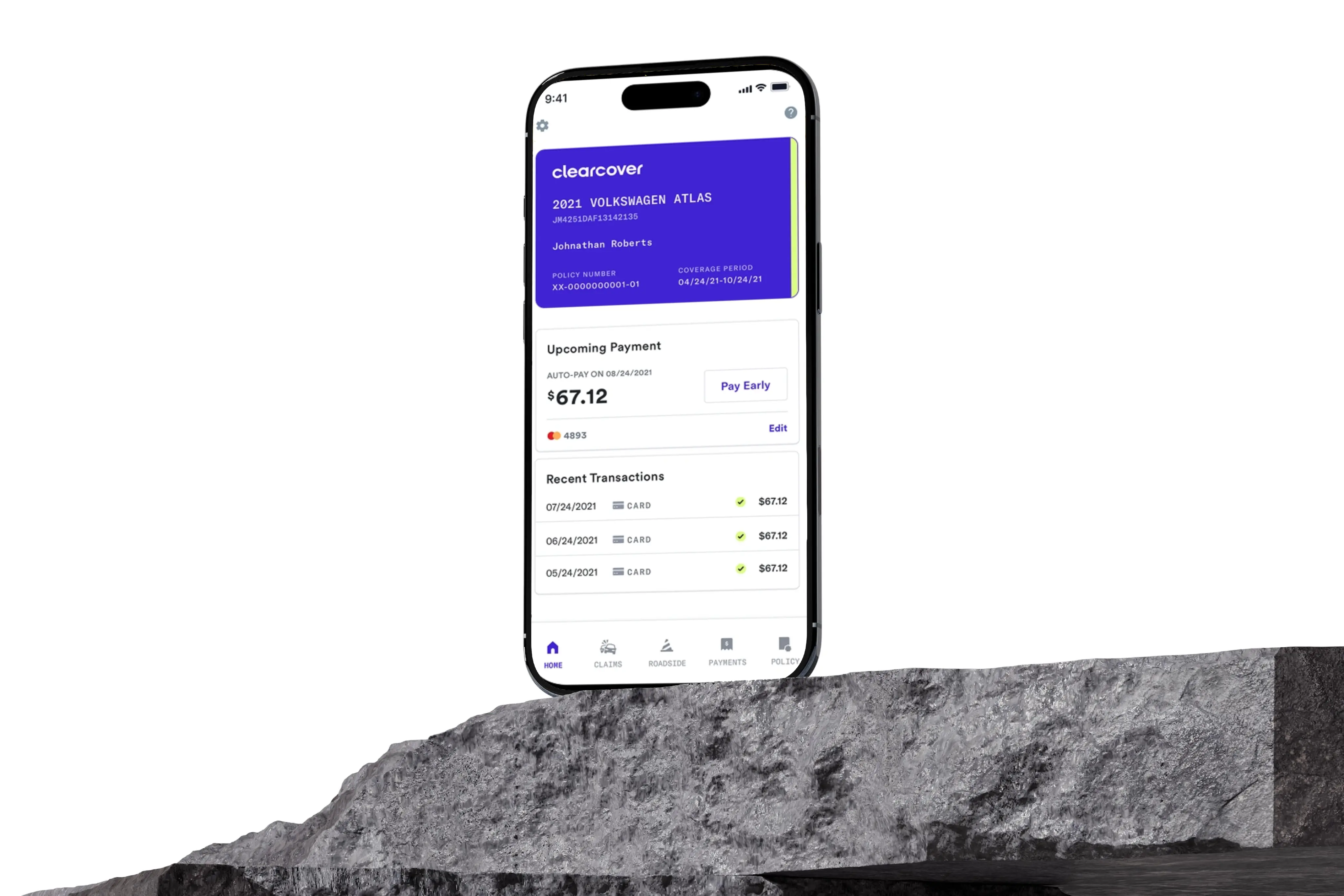 Smartphone displaying Clearcover app with vehicle insurance details and payment history on a stone surface.