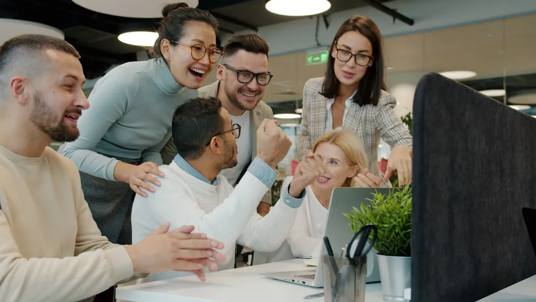A successful product development team celebrating a multi-platform app launch