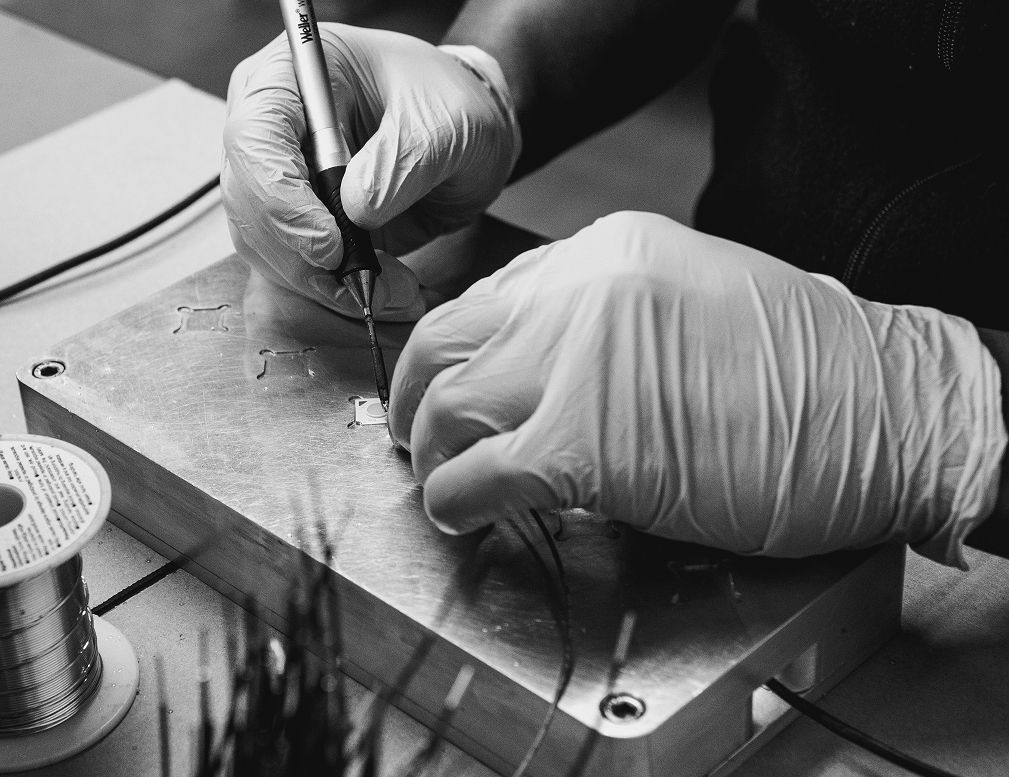 Craftsman hand-assembling a component in the workshop