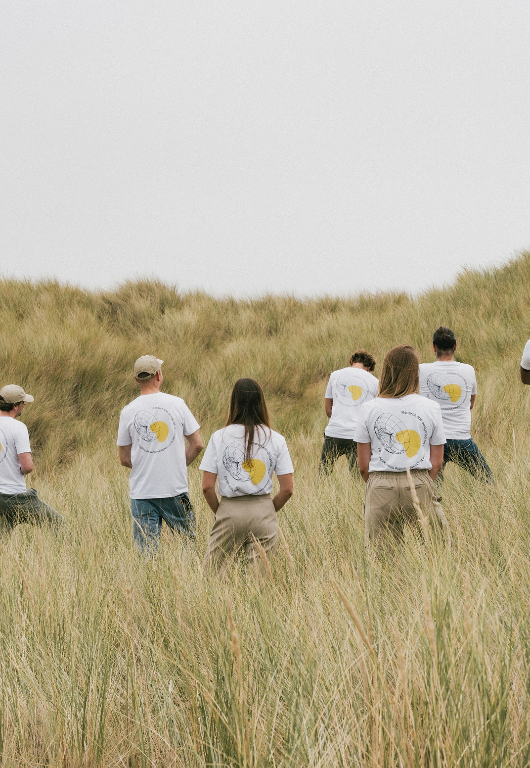 The Prado Family team walking through dunes