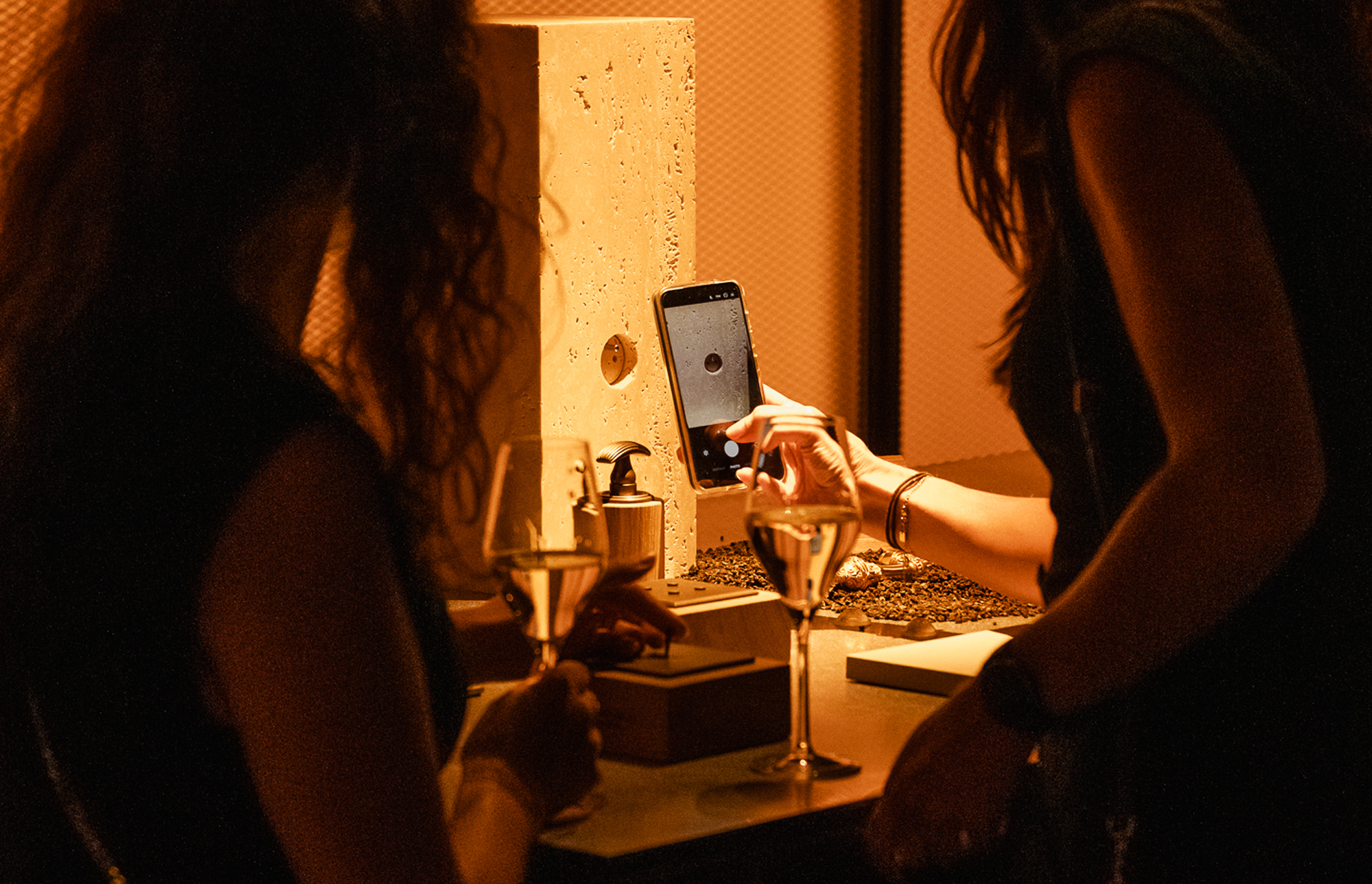 Guest taking a phone photo of a product at a prado event