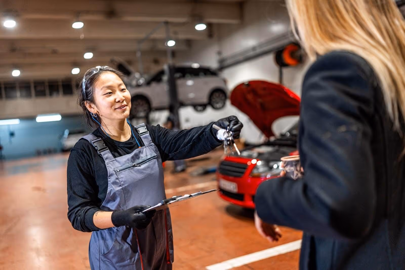 Woman talking to mechanic