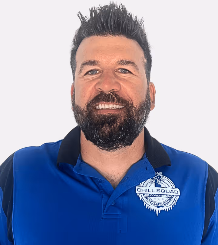 Bearded man with dark spiked hair smiling, wearing a blue Chill Squad Air Conditioning polo shirt.