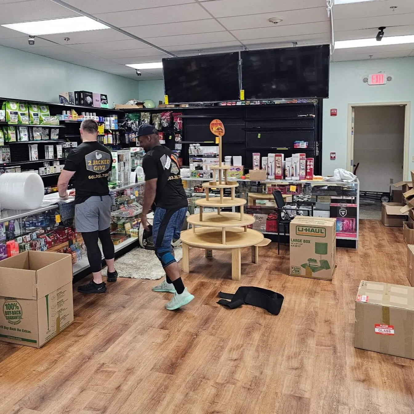 image of a humanitarian aid fundraising event, with volunteers stacking boxes in a modern yet welcoming space