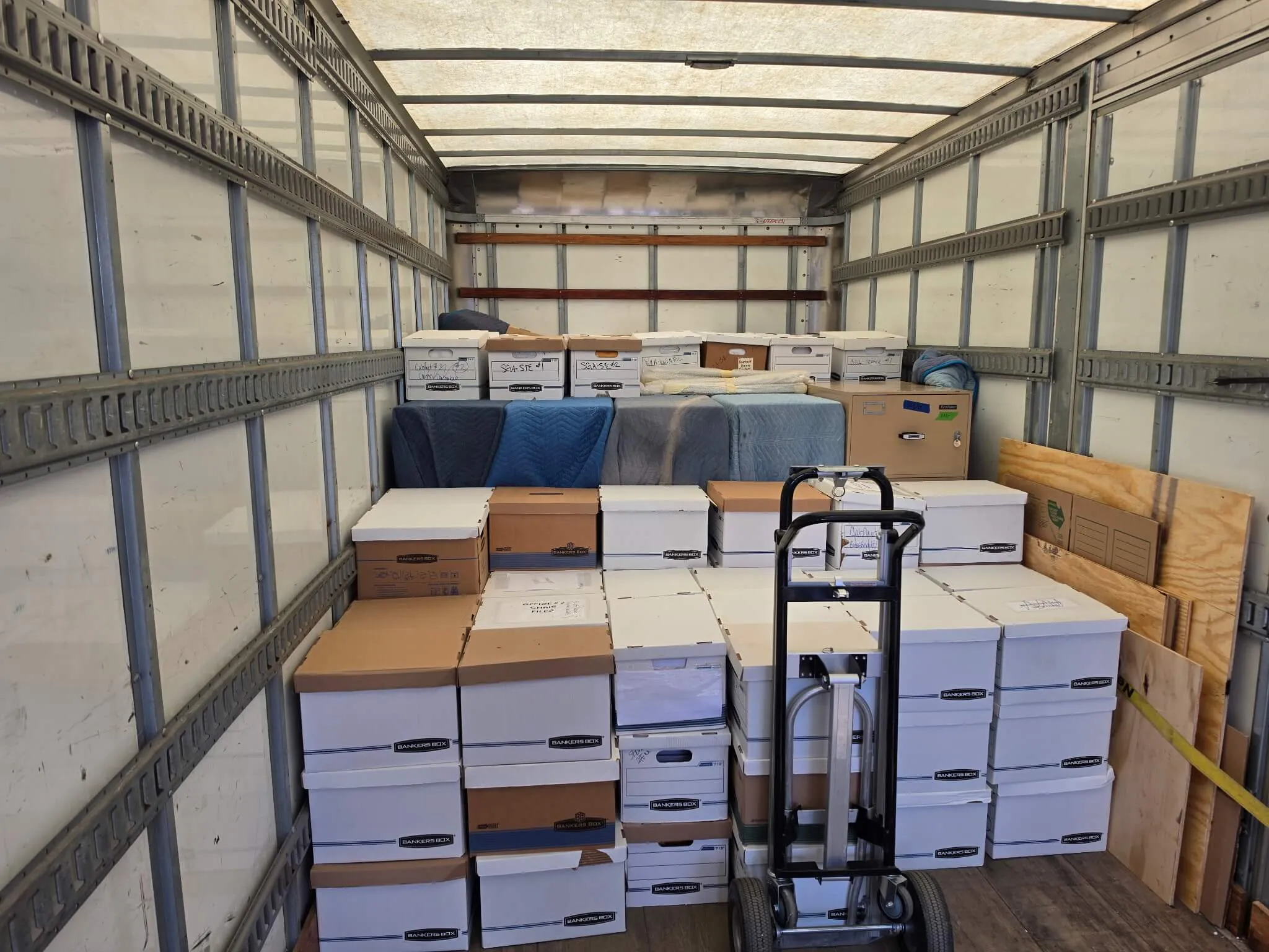 image of a humanitarian aid fundraising event, with volunteers stacking boxes in a modern yet welcoming space