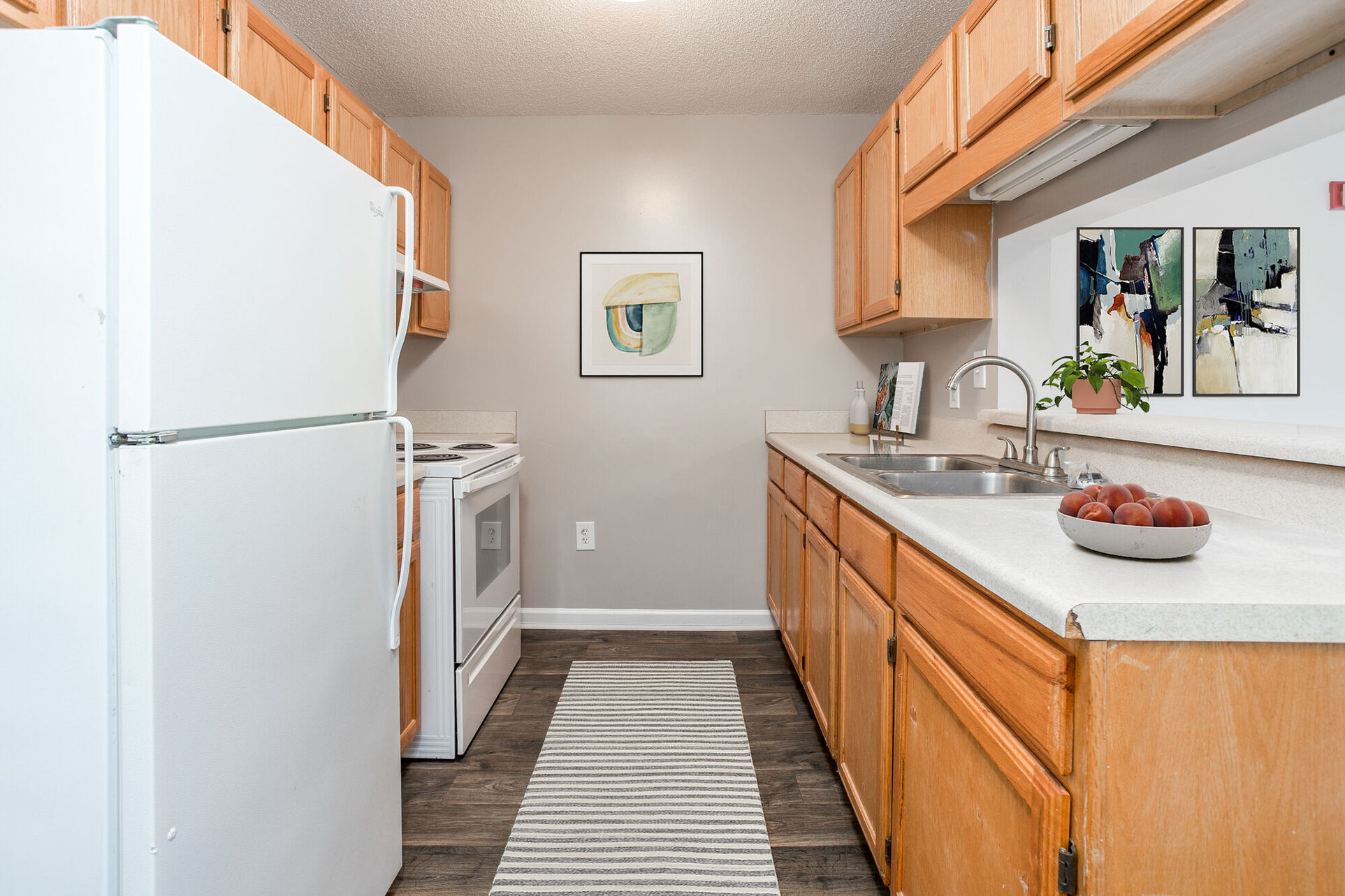 Kitchen with brown cabinets and white appliances