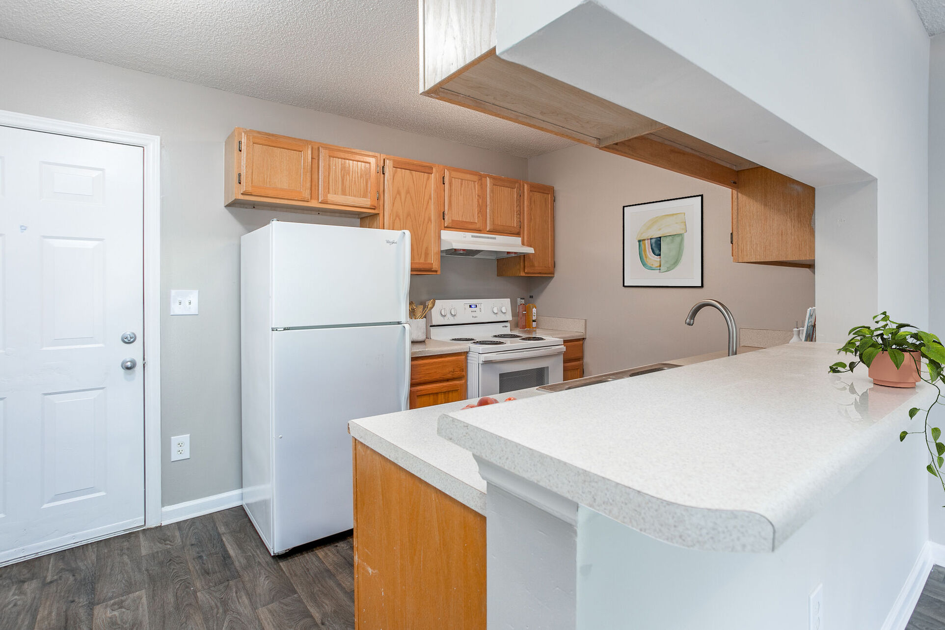 Kitchen with brown cabinets and white appliances