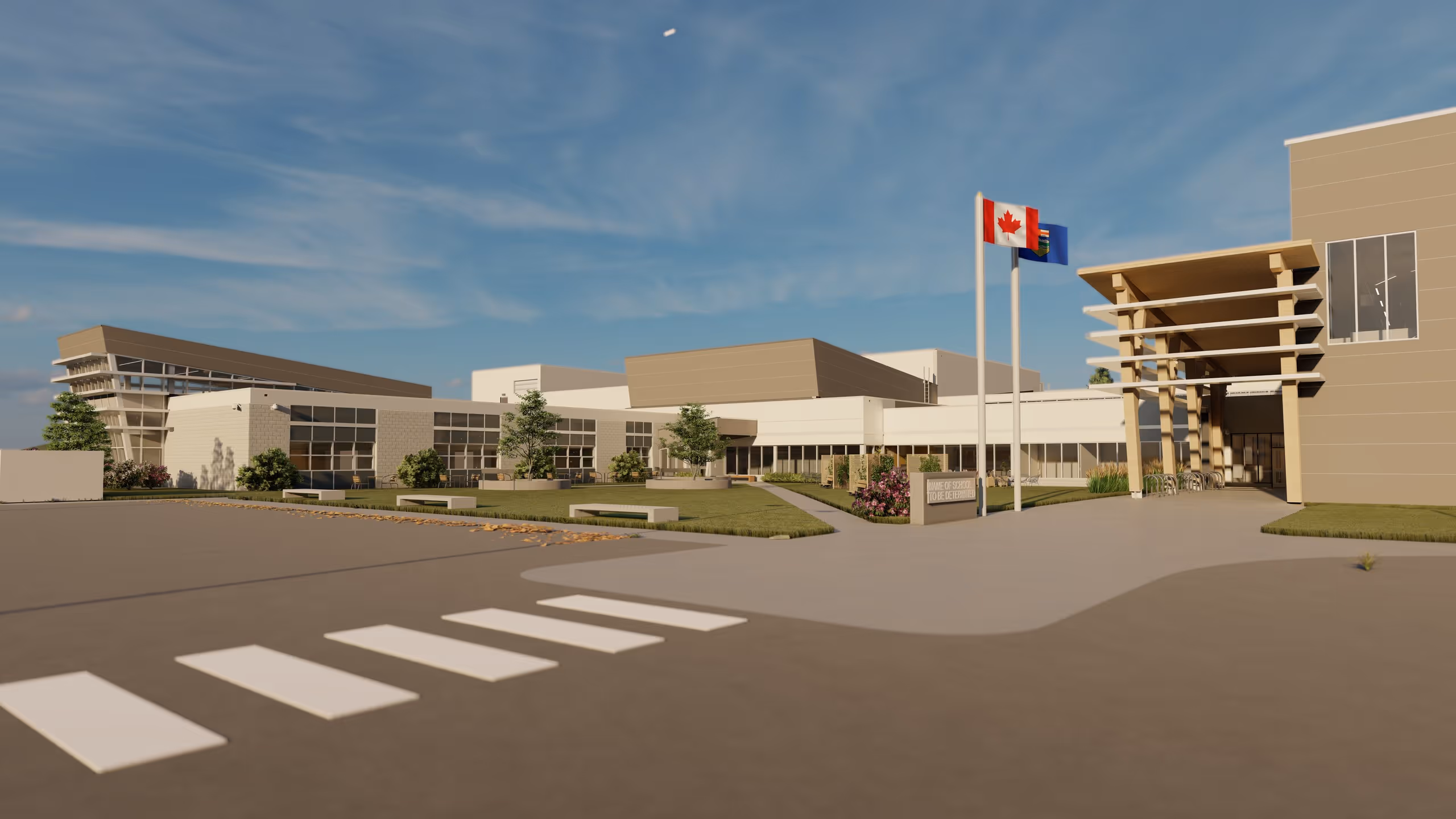 Modern school building with Canadian and Alberta flags flying at the entrance under a clear blue sky.