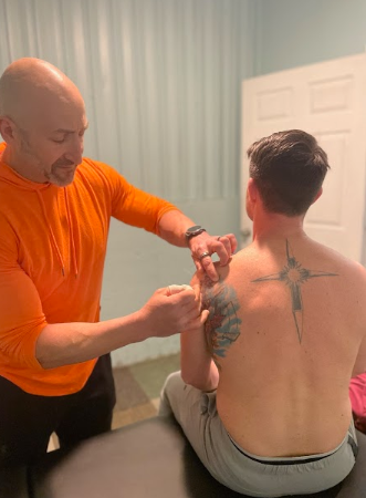 Patient receiving one-on-one manual therapy from a physical therapist at a sports physical therapy clinic in Derry, NH