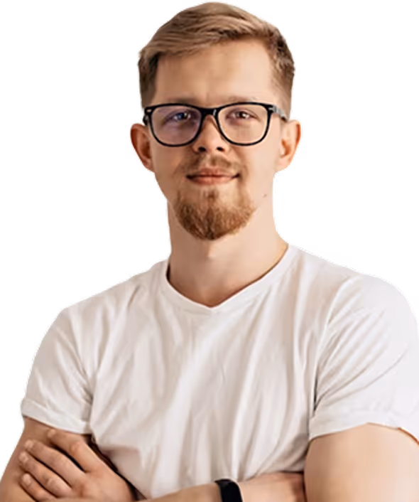 Young man with blond hair, glasses, and a short beard, wearing a white t-shirt with arms crossed.