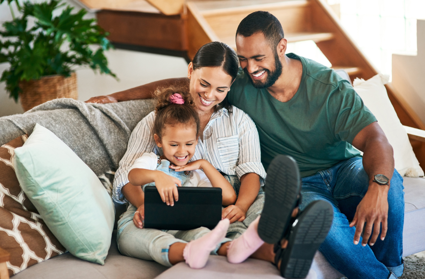 Family sitting on couch smiling stock image