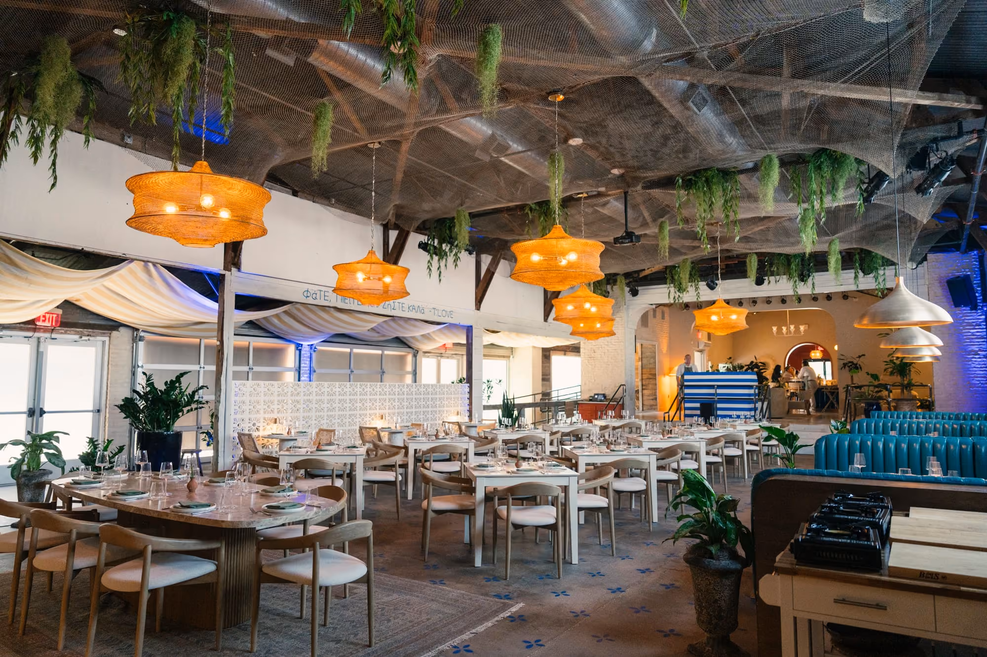 Meraki's Main Dining Room seats guests under woven pendant lights and trailing greenery for full-scale events.