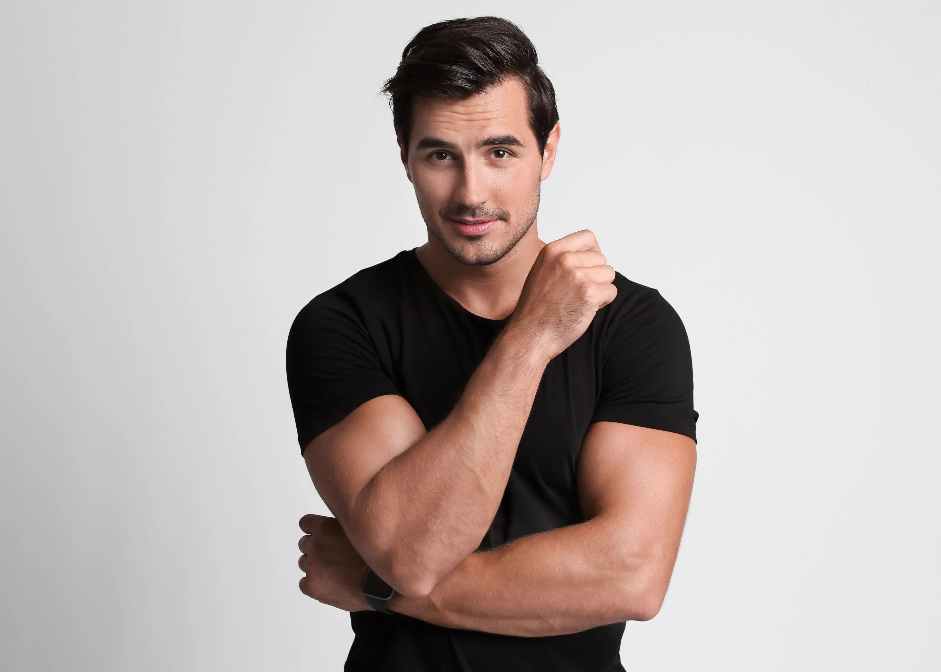 A man in a black shirt is posing for a picture.