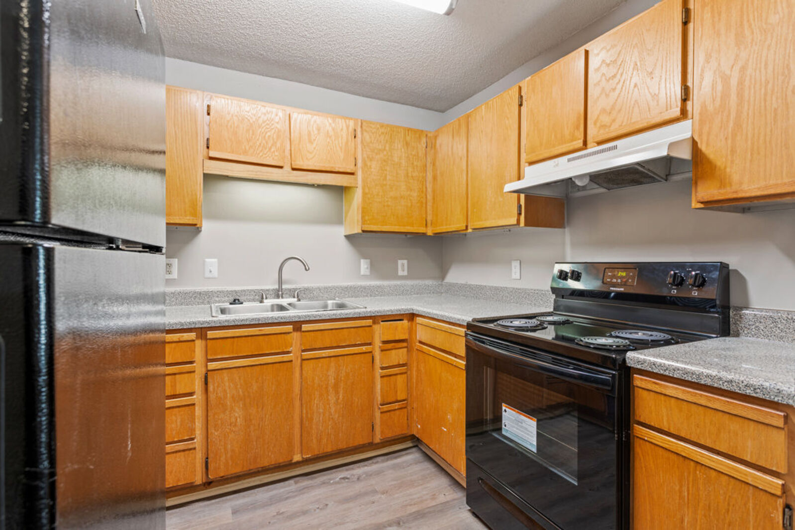 Kitchen with black appliances and brown cabinets