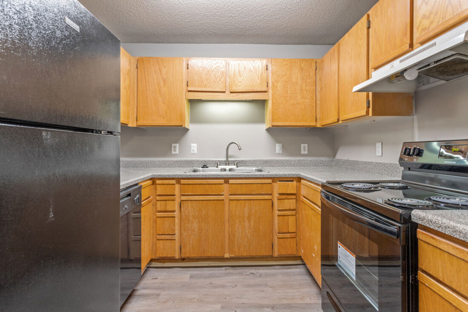 Kitchen with black appliances and brown cabinets