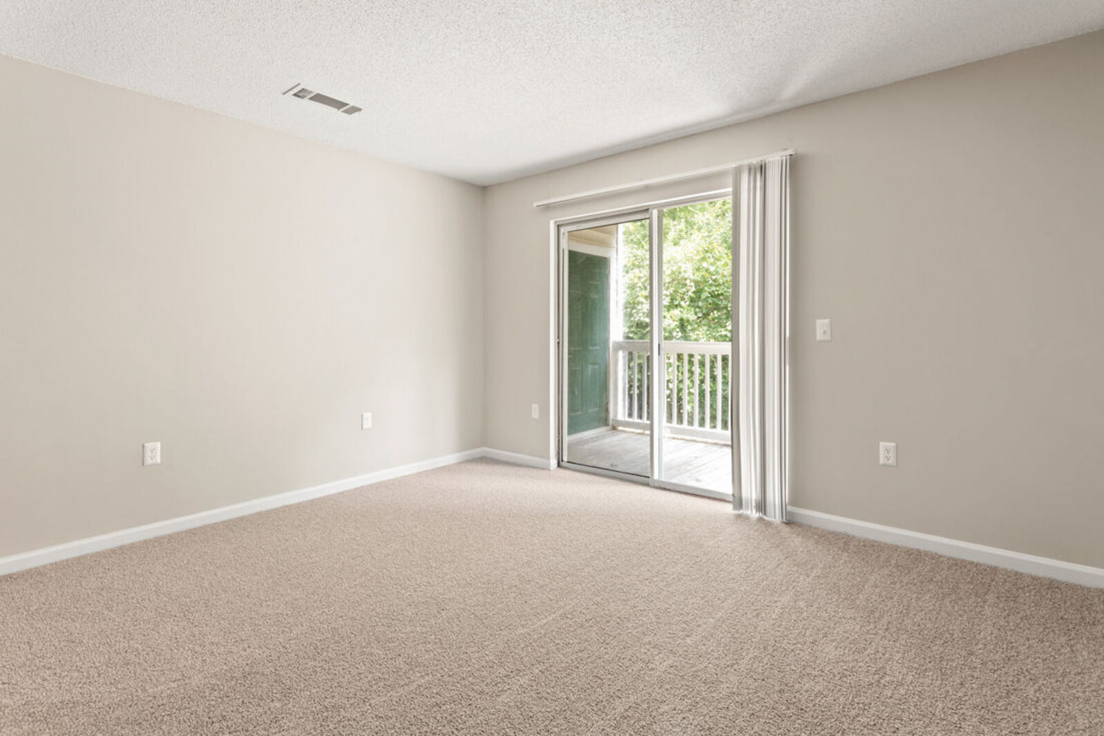 Empty living room with a sliding glass door