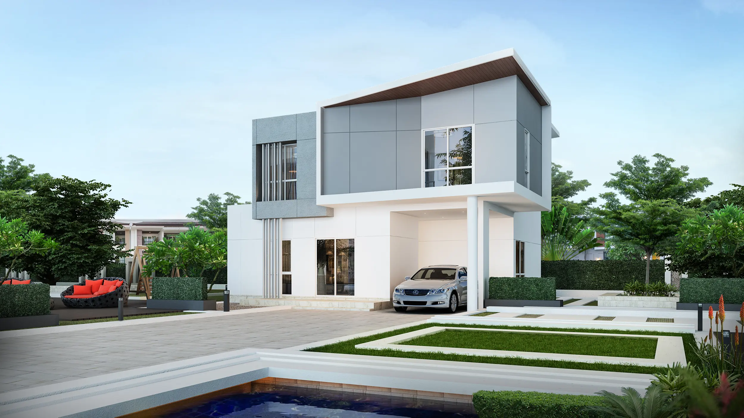 Modern two-story house with gray and white exterior, a car parked in the driveway, landscaped lawn, and outdoor seating area with red cushions.