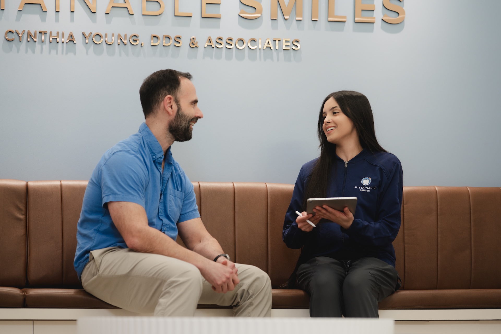 Our dental team explaining his tooth restoration options to a smiling patient